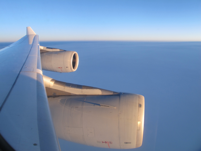 The sun greets us as we fly over the UK after I managed to actually sleep on a plane. Photo © 2011 Aaron Saunders