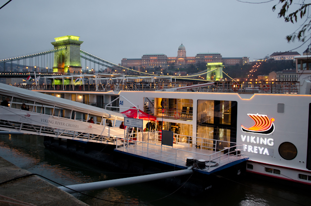 Welcome Aboard! Viking Freya lying in wait at her Budapest dock on a grey December afternoon. Notice the green illumination on the Chain Bridge in the background: for the first few moments when the lights are switched on, the structure temporarily glows green. Photo © 2012 Aaron Saunders