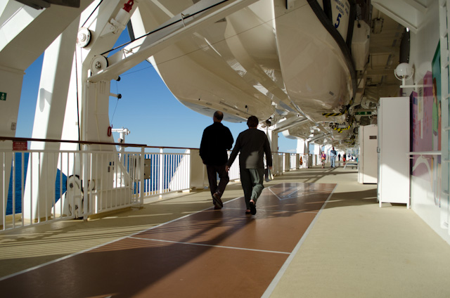 Guests stroll along the wide, wraparound Promenade Deck on Deck 7. Photo © 2013 Aaron Saunders