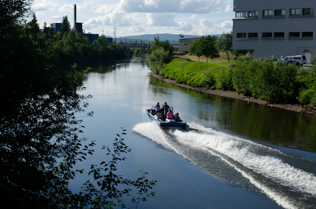 A boat zips by in the early evening on the Chena River that winds its way through Fairbanks. Photo © 2013 Aaron Saunders