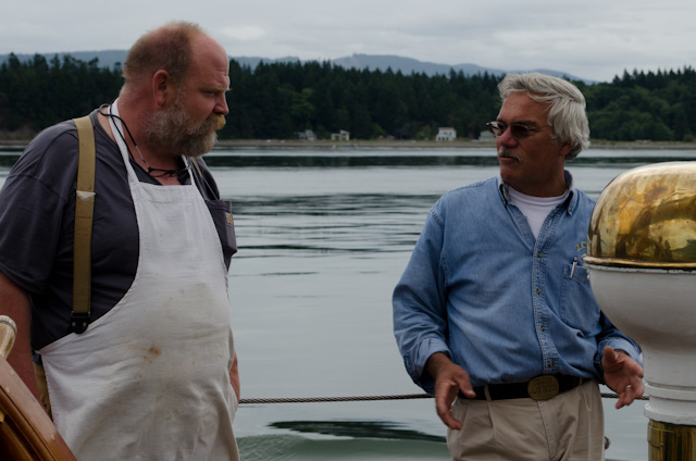 Cook Ian Relay, left, chats with Captain Tim Mehrer as we sail out of Bellingham, Washington. Photo © 2013 Aaron Saunders