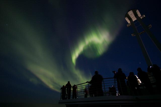 Guests aboard the Silver Explorer admire the Northern Lights high above Canada's Arctic. Photo courtesy of Silversea