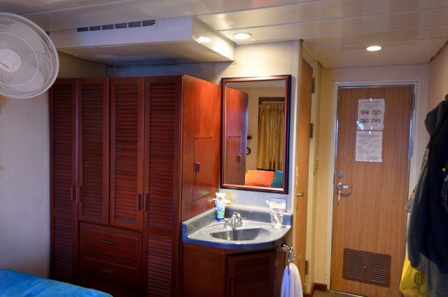 The reverse angle of Commander Stateroom 217, showing the in-room sink and vanity and the air conditioning unit (upper left, above the wardrobe.) Photo © 2014 Aaron Saunders