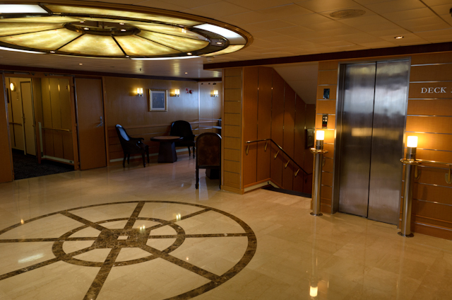 Off to the starboard side of the reception area is the ship's central staircase and elevator. Photo © 2014 Aaron Saunders