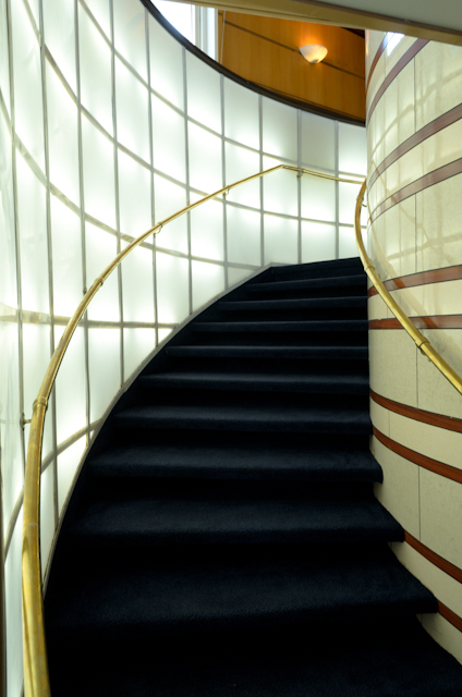 A curved, backlit staircase provides access to the Explorer Room on Deck 3, below. Photo © 2014 Aaron Saunders