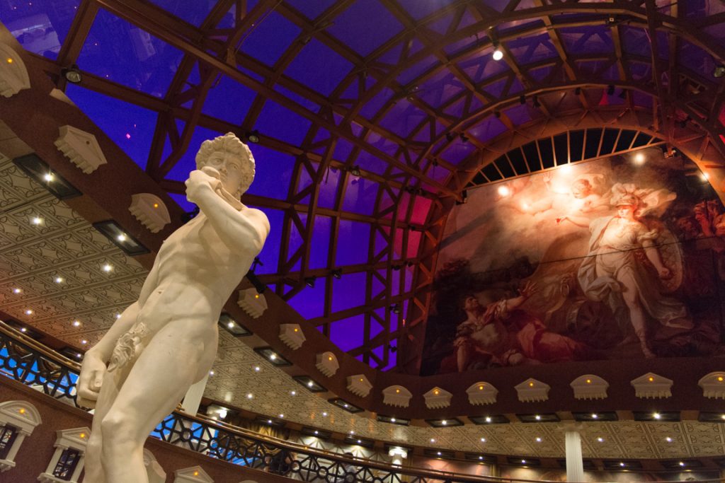Carnival Pride's David's Steakhouse, by dusk. The replica of Michelangelo's David is pretty good, save for the 'modesty leaf.' Photo © 2016 Aaron Saunders