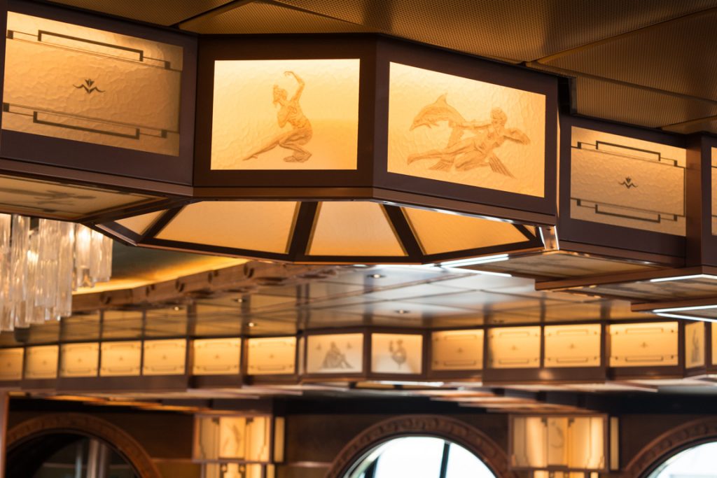 At two decks in height, the dining room features subtle backlit panels that work their way attractively into the overall decor scheme. Photo © 2016 Aaron Saunders