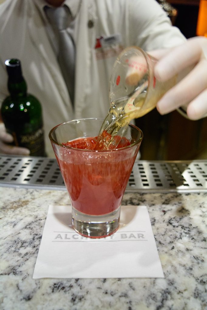 Mixing a drink in Alchemy: first the ingredients (that you choose) are poured in. Photo © 2016 Aaron Saunders